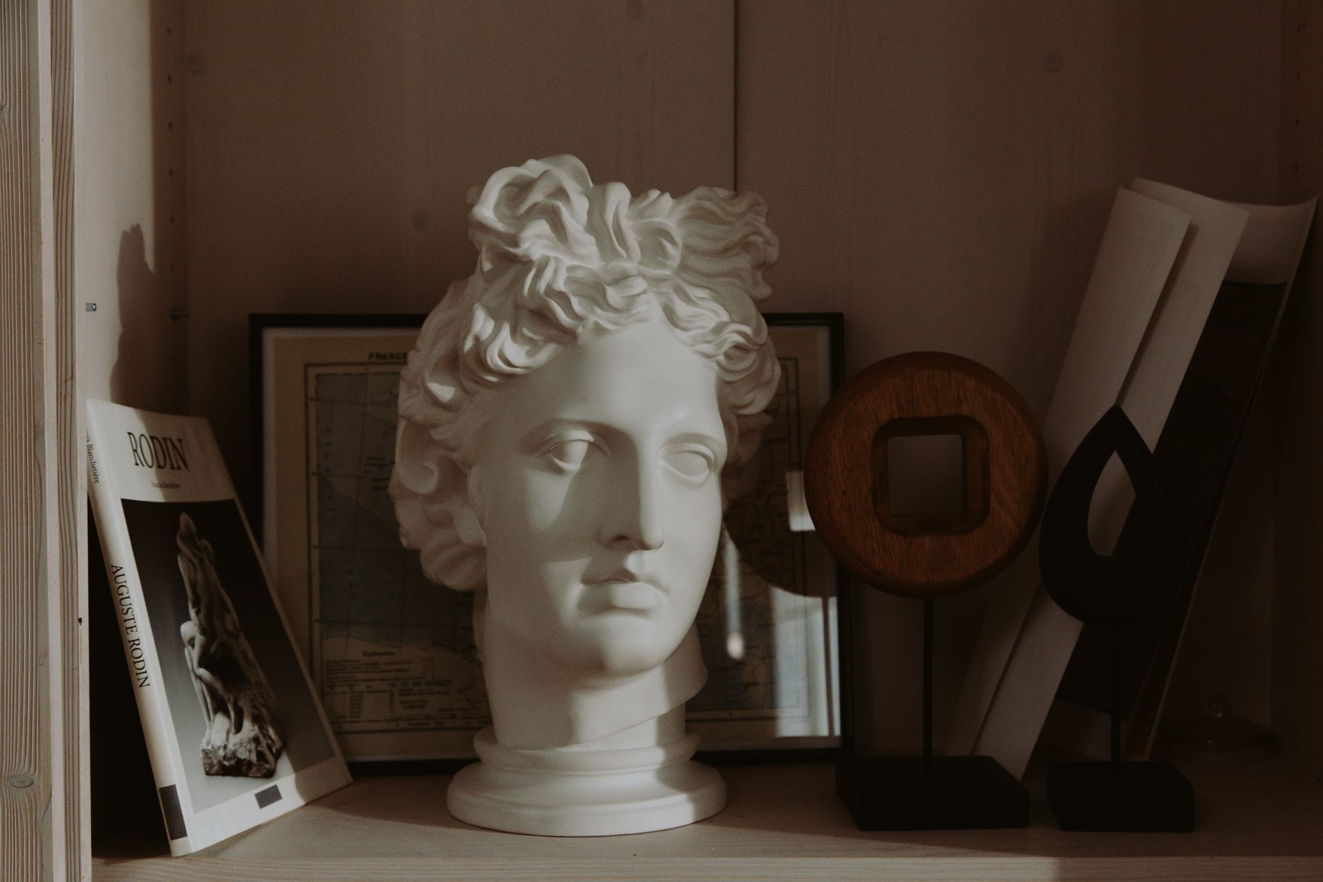 White Head Bust on White Wooden Shelf