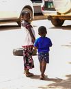 Boy in Blue Crew Neck T-shirt Standing Beside Girl in Blue Dress