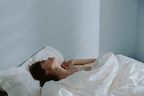 A Woman Sleeping on the Bed 