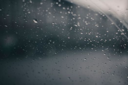 Moody raindrops on glass create an atmospheric background.
