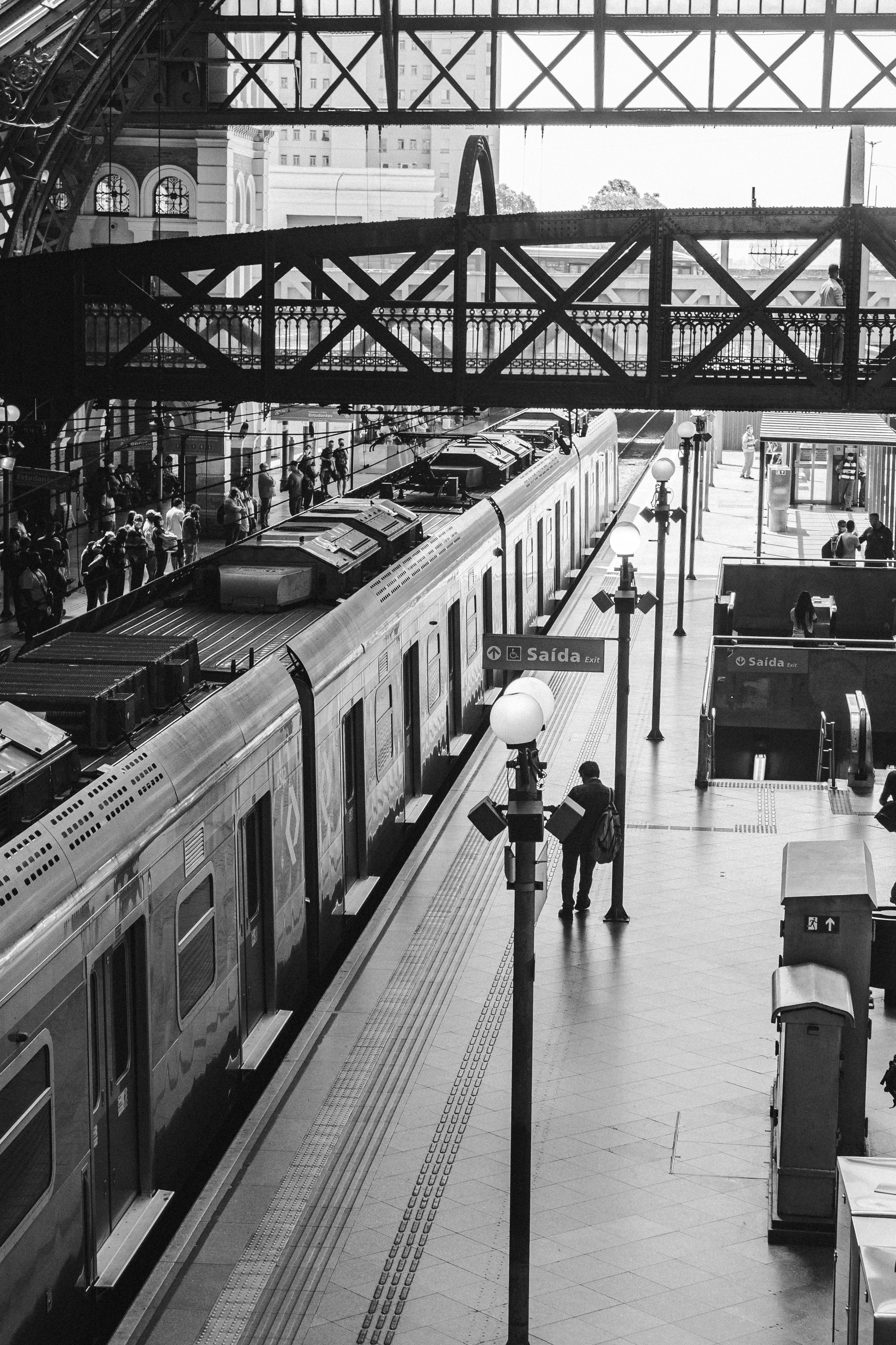 Grayscale view of a bustling train station in São Paulo, Brazil, capturing daily commute.