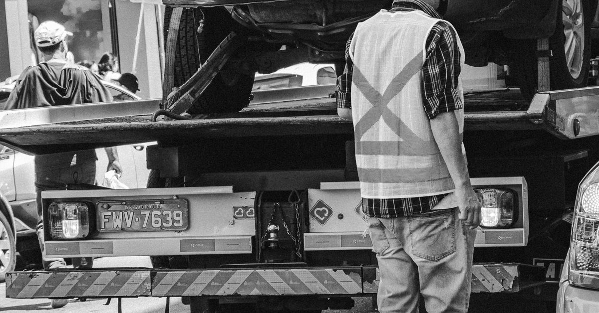 A tow truck carrying a car — releasing a towed vehicle may need a notarized authorization
