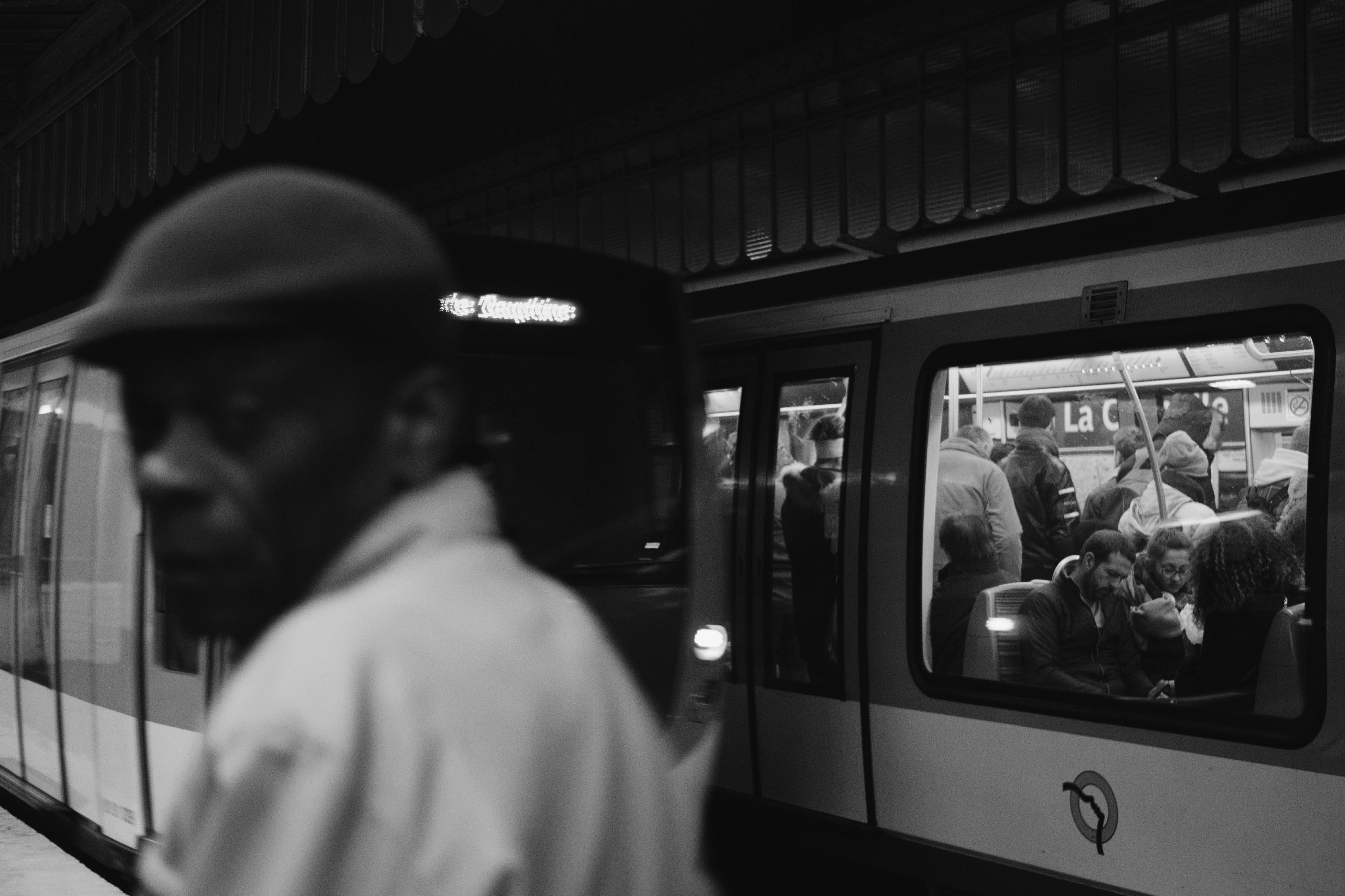 grayscale photo of people inside train