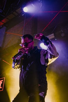 A dynamic live performance of a singer at a concert with vibrant lighting and atmosphere.