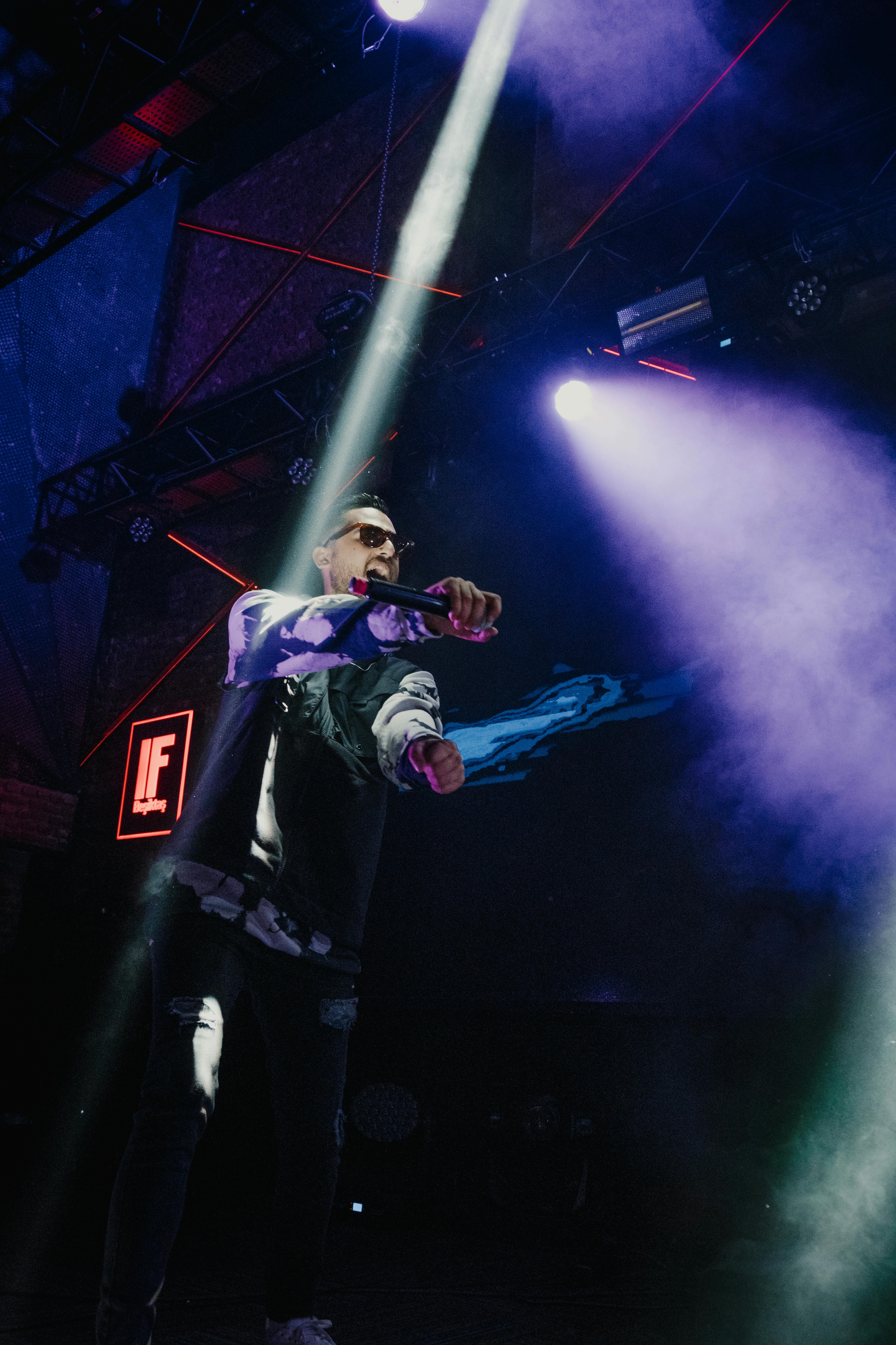 a low angle shot of a man standing on stage