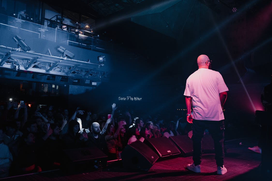 Male Rapper Performing on a Stage · Free Stock Photo