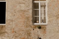 A White Window Frame with Glass on a Concrete Wall