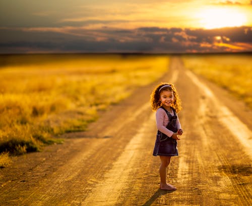 Free Girl Standing in the Middle of the Road Stock Photo