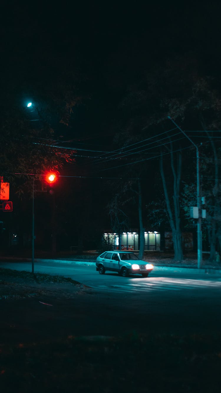 A Car On Road Stopping For The Traffic Light