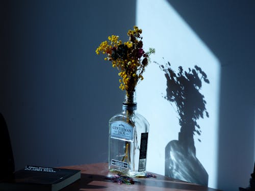 A Yellow Flowers on a Glass Bottle