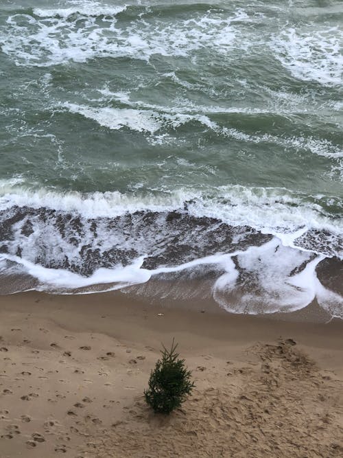 An Aerial Photography of Beach Waves Crashing on Sand