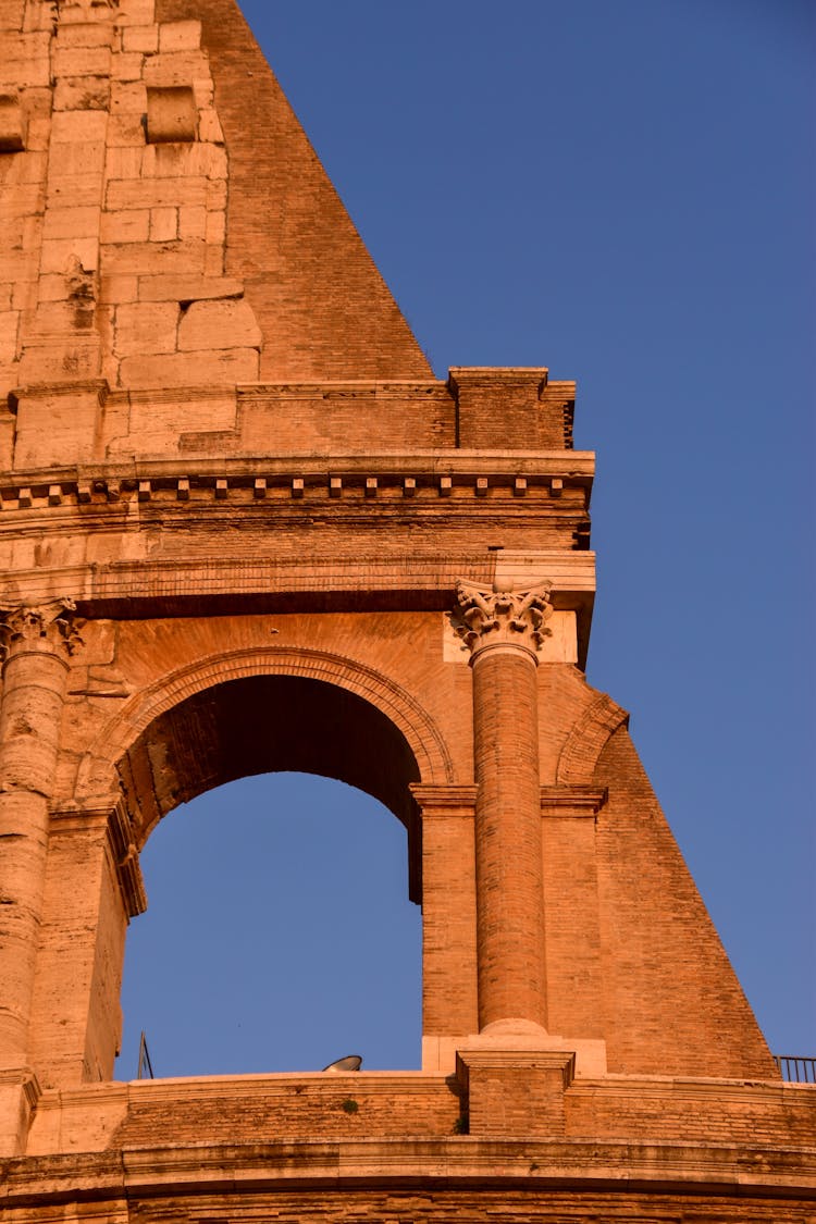 Arch And A Column Of The Colosseum In Rome, Italy