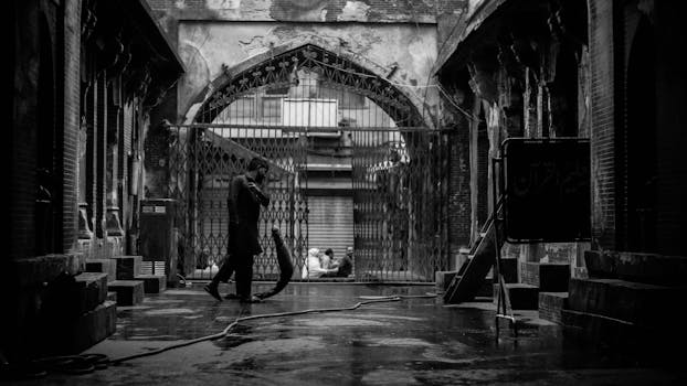 一名孤独的男子走在历史悠久的封闭城区潮湿的街道上