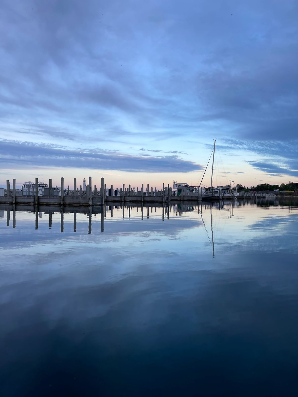 Boat docks on calm water at dusk