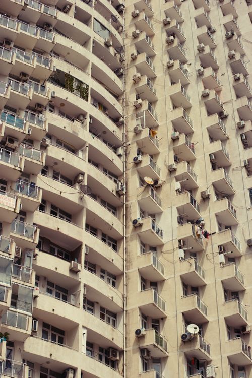 Free Vertical image of apartment building with balconies and AC units. Stock Photo
