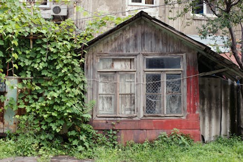 A Shabby Wooden House with Broken Glass Window