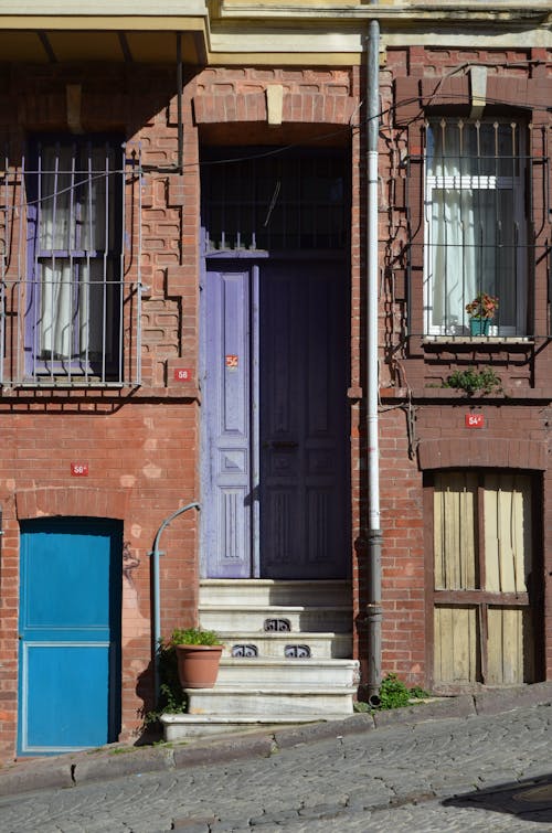 Brown Brick Building With Purple Wooden Door