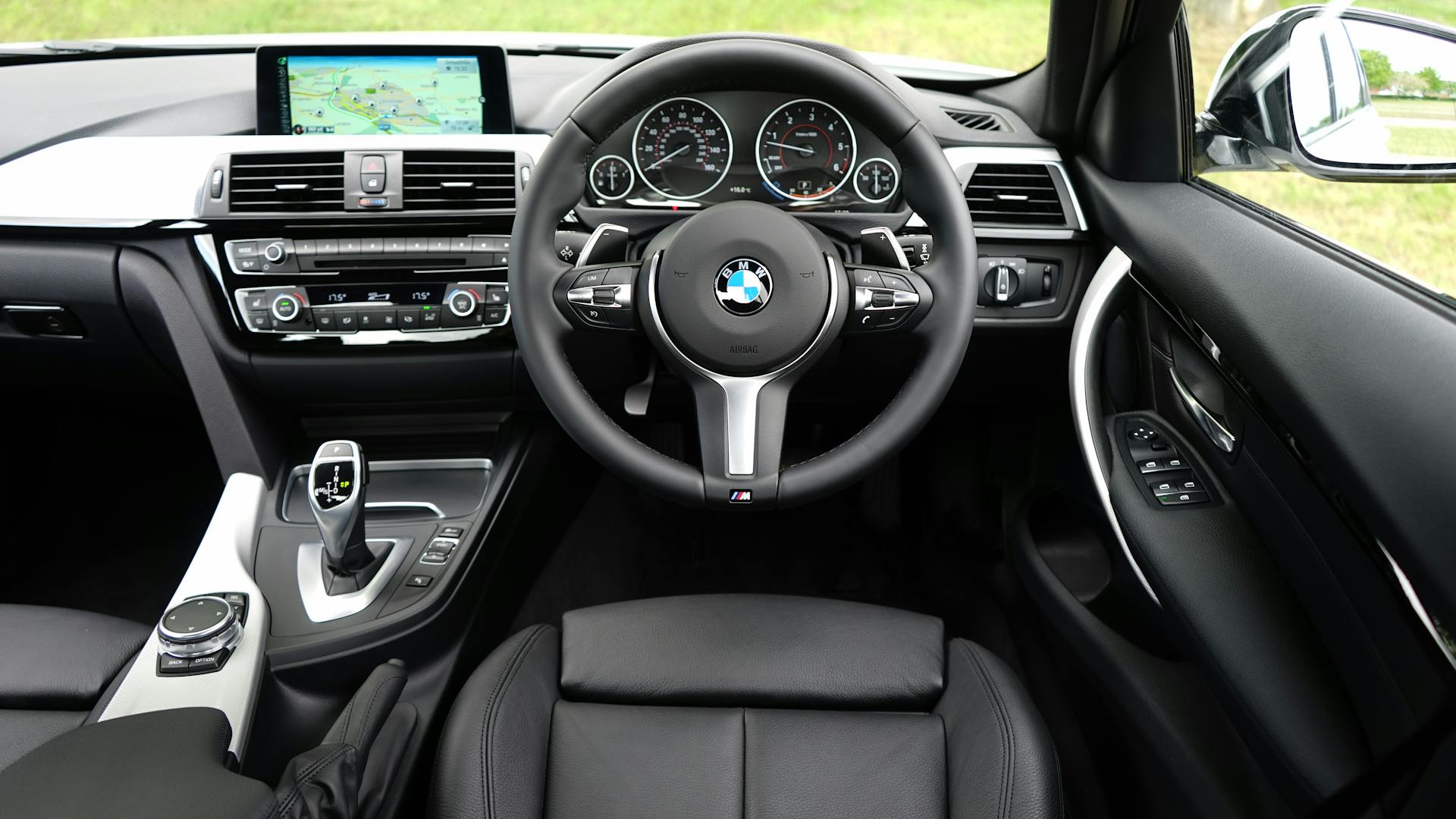 Explore the luxurious interior of a BMW car featuring a modern dashboard and navigation system.