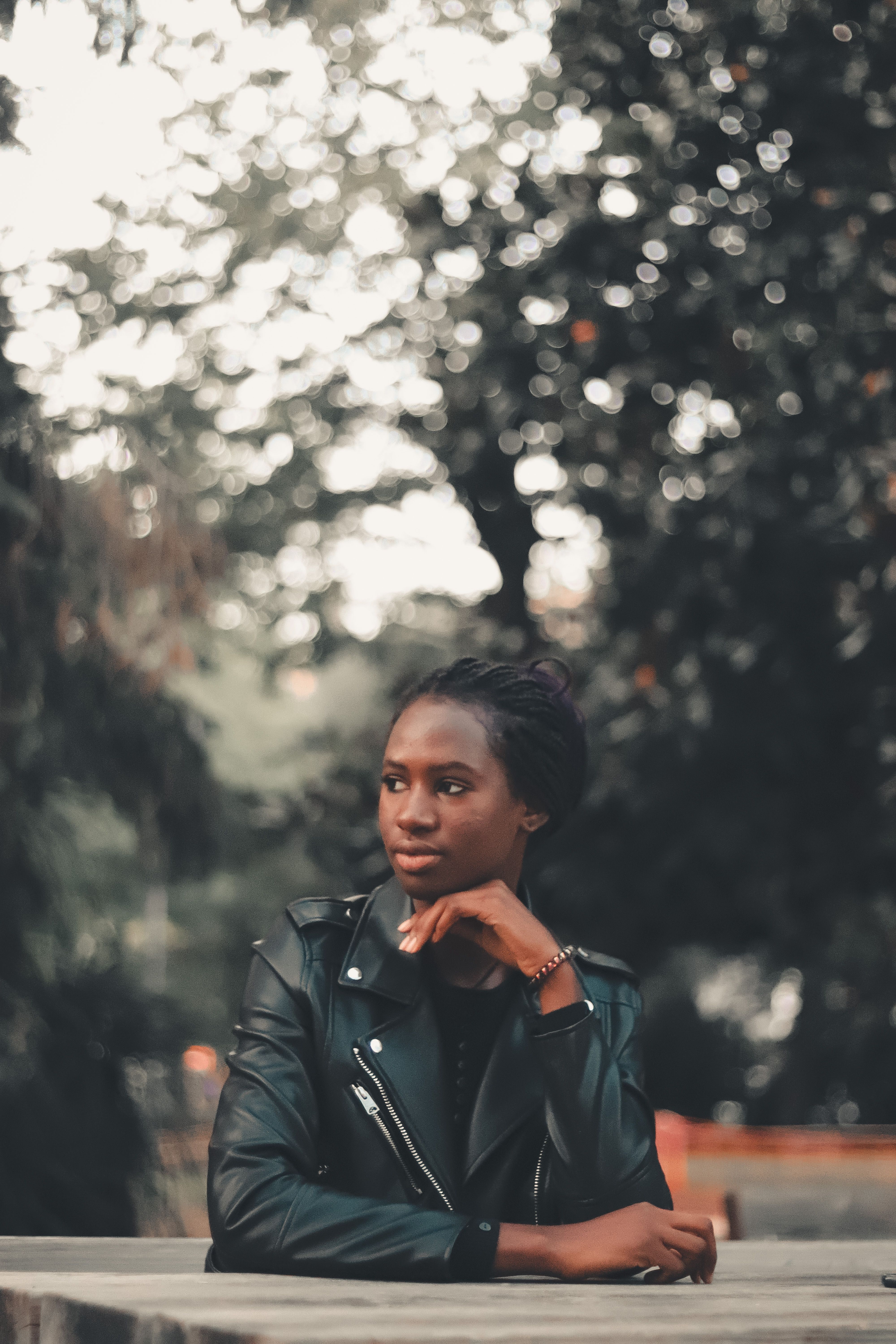 Woman in Black Leather Jacket Sitting 