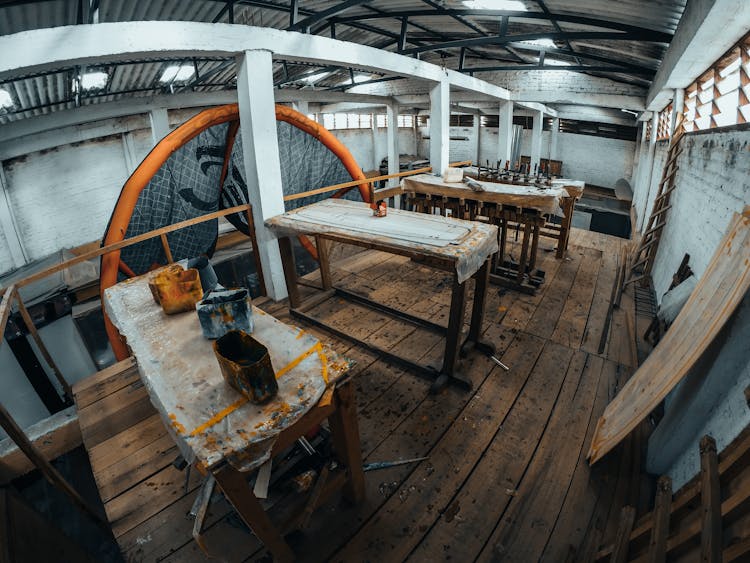 Wooden Tables With Paint In Workshop