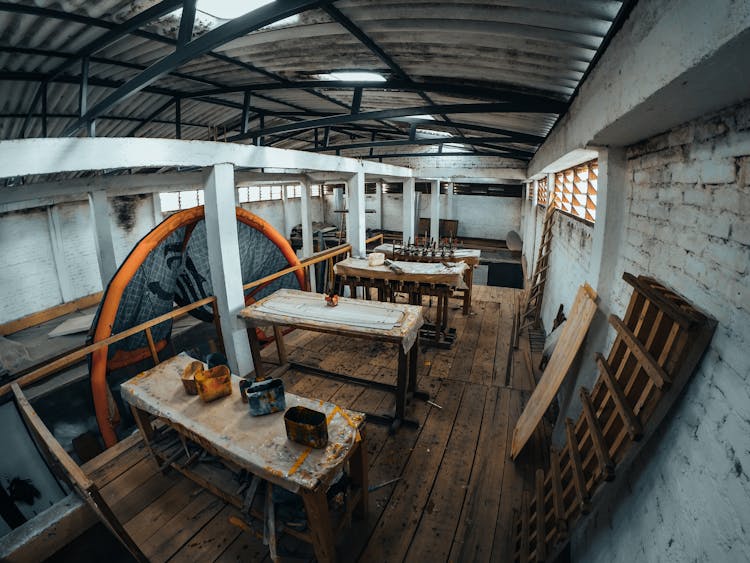 Wooden Tables In Abandoned Workshop