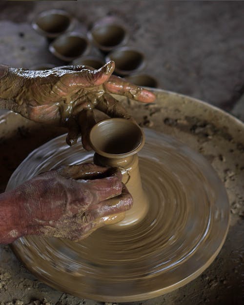 A Person Molding a Clay