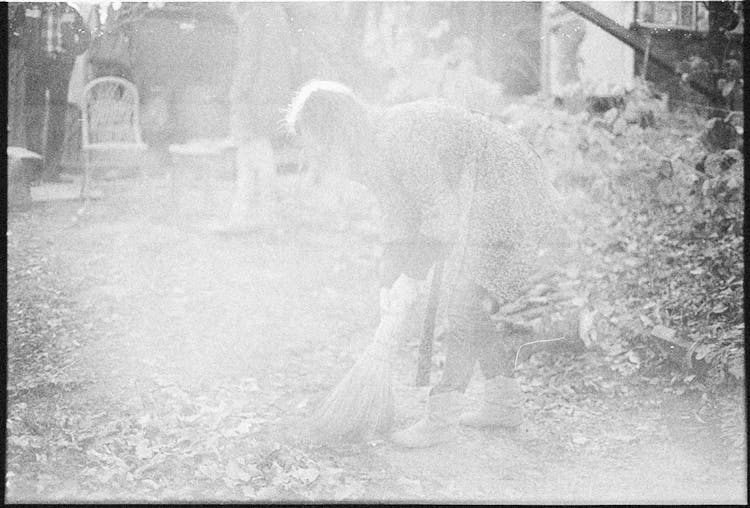 Retro Picture Of Woman Sweeping On Street