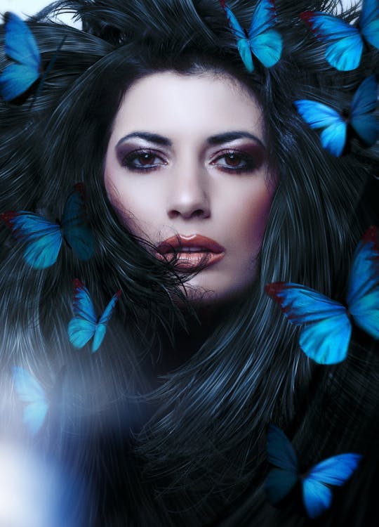 A Beautiful Woman with Butterflies on Her Hair