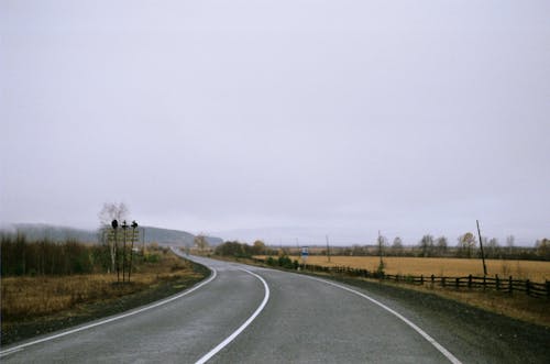 Empty Road Between Fields