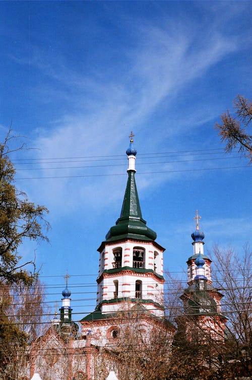 White and Green Church Building Under Blue Sky