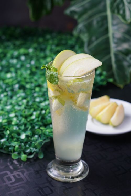 Free Chilled lemonade with apple slices and mint, perfect for a refreshing summer day. Stock Photo