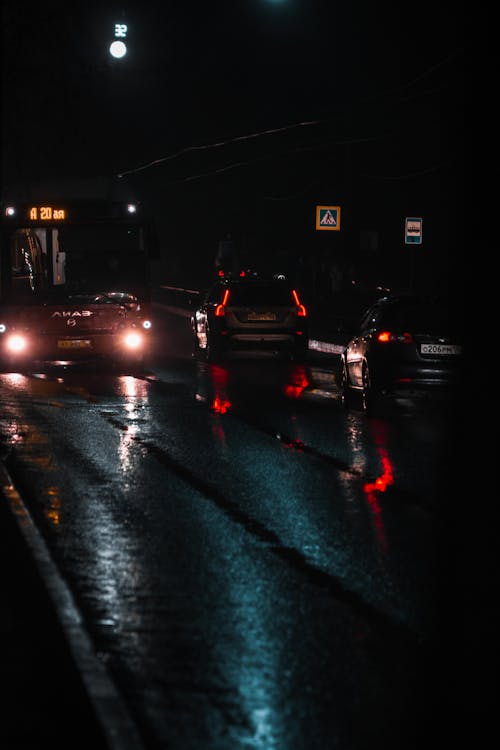 Vehicles on the Wet Road During Night Time