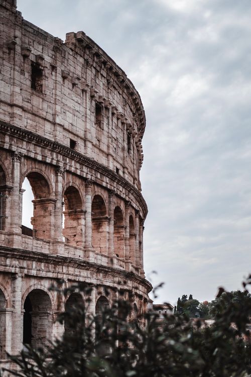 Free Dramatic view of the ancient Colosseum with cloudy skies in Rome, Italy. Stock Photo