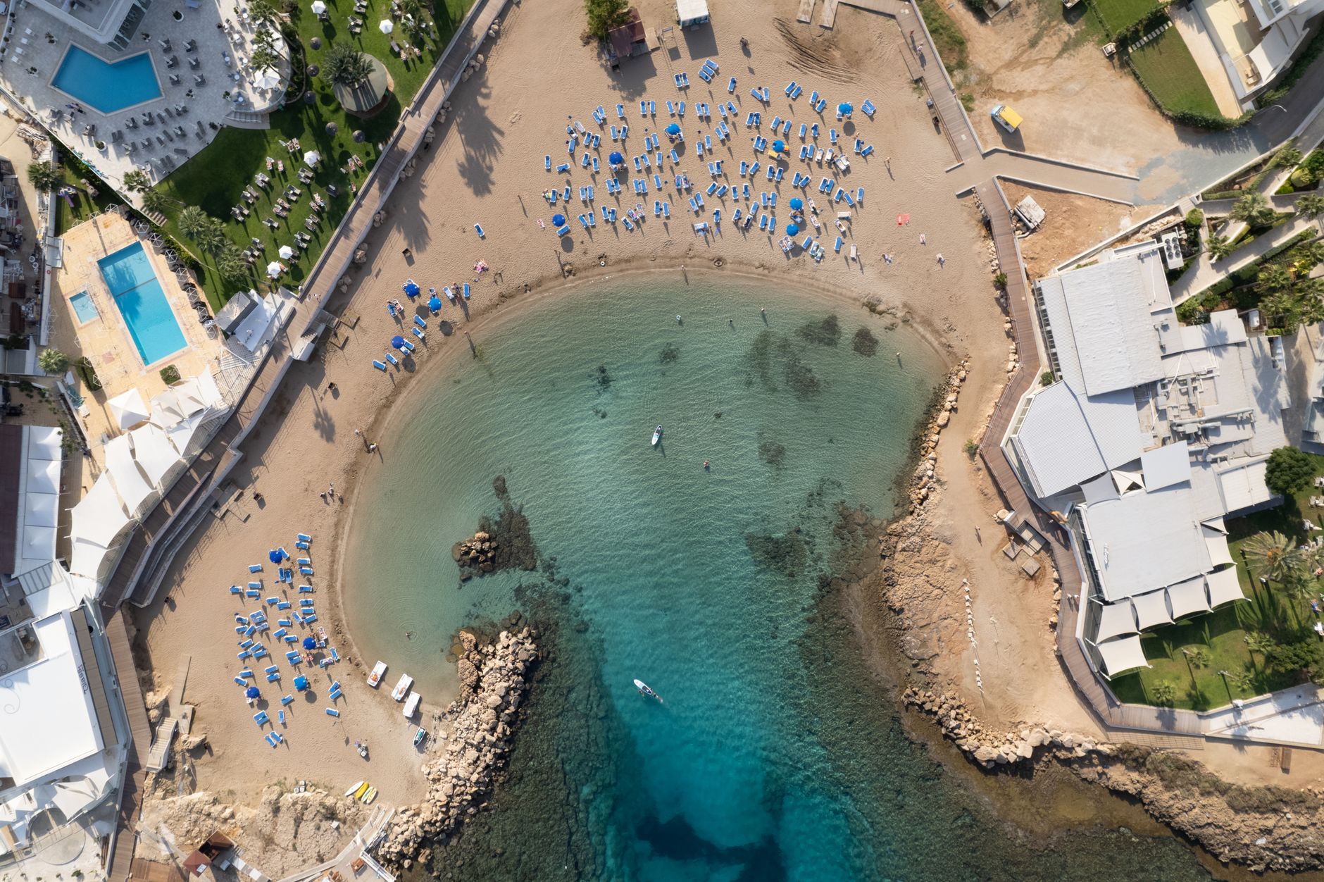 Stunning aerial shot of Protaras beach in Cyprus with clear blue waters and sun loungers.
