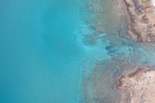 Free A serene aerial view of the turquoise coastline in Pernera, Famagusta, Cyprus. Stock Photo