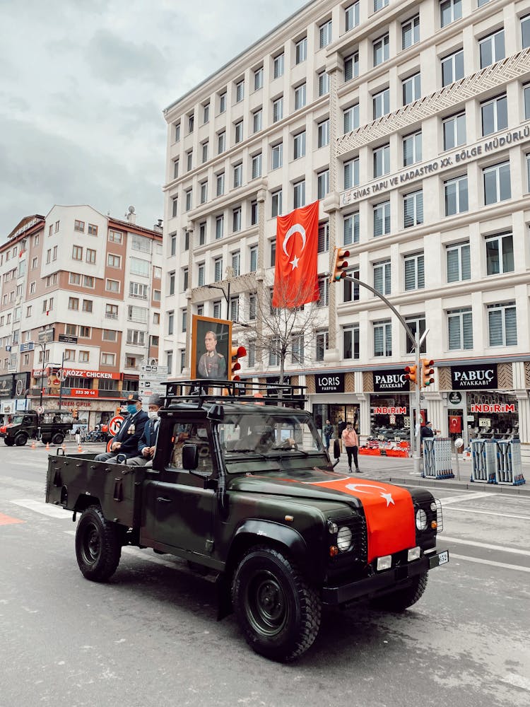 A Vintage Military Land Rover Defender Pickup Truck In An Urban Area