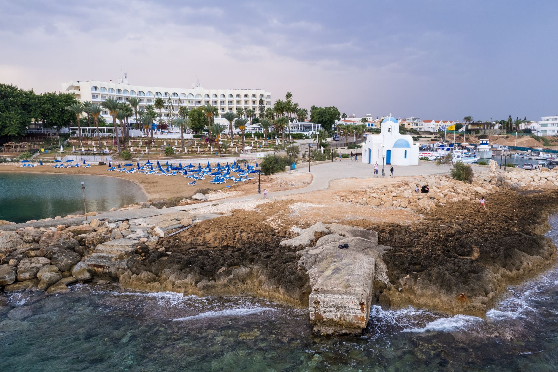 Aerial view of a church near the beach in Pernera, Cyprus, capturing the serene coastal landscape. — photo by Ollie Craig / Pexels