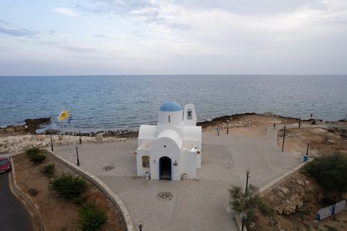 Free Aerial view of a white church with a blue dome by the sea in Pernera, Famagusta, Cyprus. Stock Photo