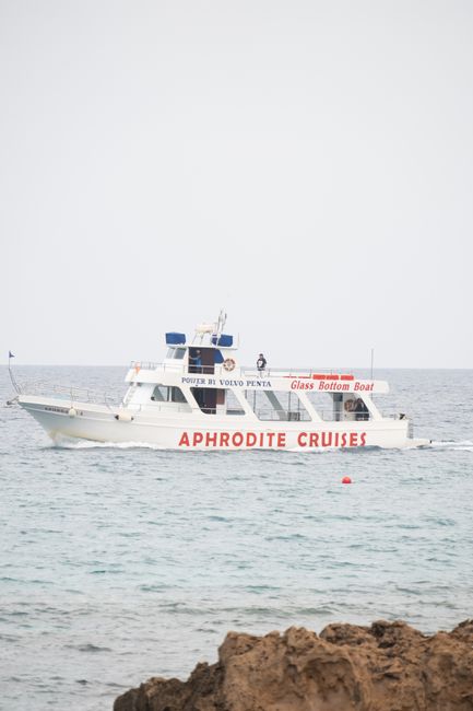 Glass bottom boat of Aphrodite Cruises sailing on the tranquil sea, Cyprus.