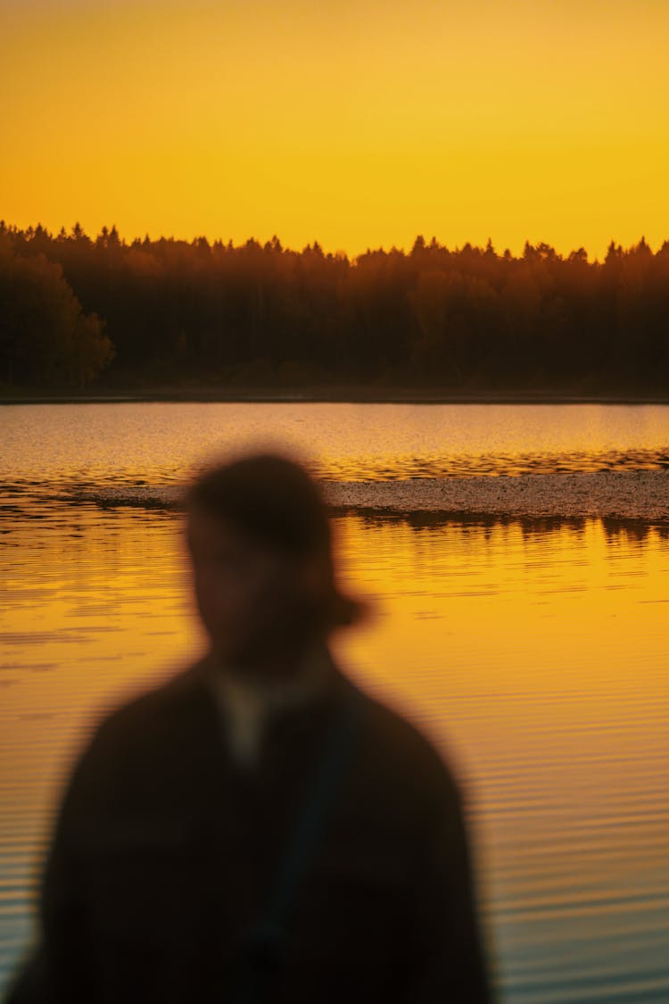 Blurred Woman On Lakeshore At Sunset