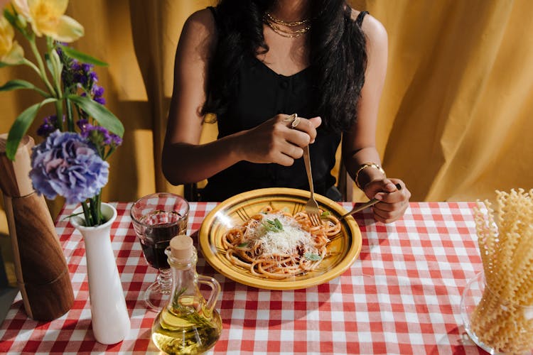 Woman Eating Plate Of Bolognese