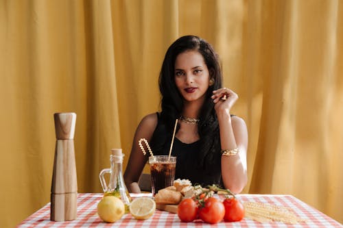 Portrait of Woman Sitting at Table With Food