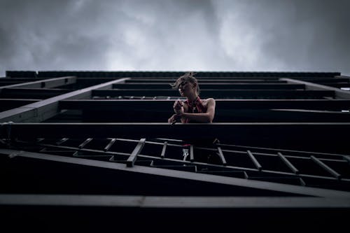 Low Angle Shot of a Woman at a Balcony