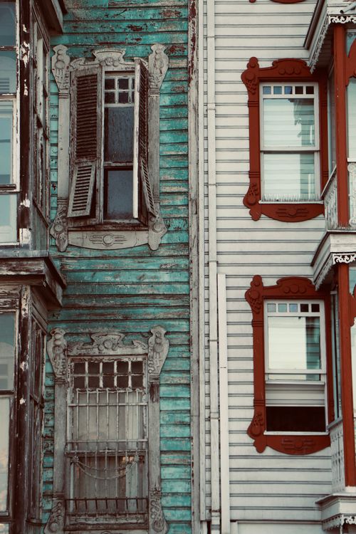Free Close-up shot of vintage wooden facades showcasing detailed window frames and weathered charm. Stock Photo