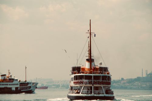 Free A ferry sailing on the Bosphorus Strait with city skyline in the background. Stock Photo