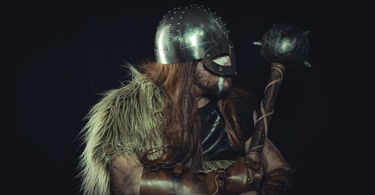 Viking warrior in medieval armor holding a mace, with fur cloak and metal helmet.
