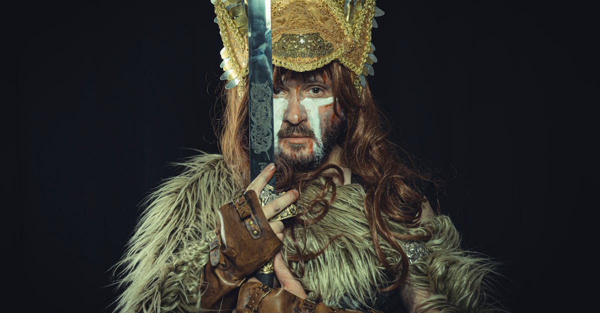 A dramatic portrait of a Viking warrior in costume holding a sword, featuring a golden headdress and fur garment.