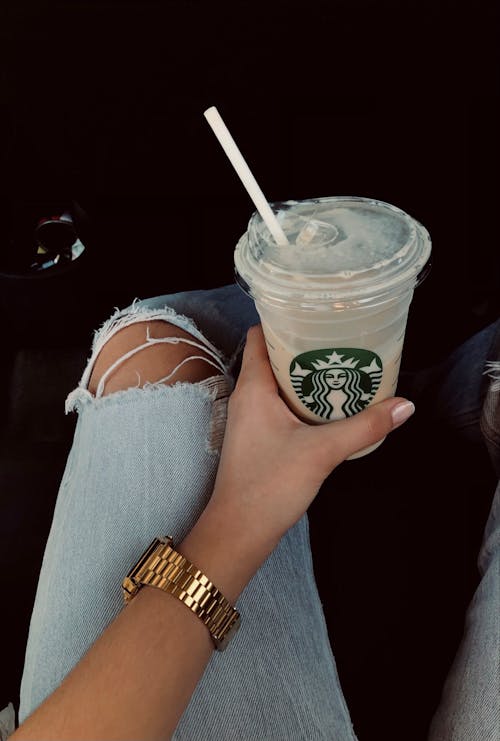 A Woman Holding a Starbucks Drink