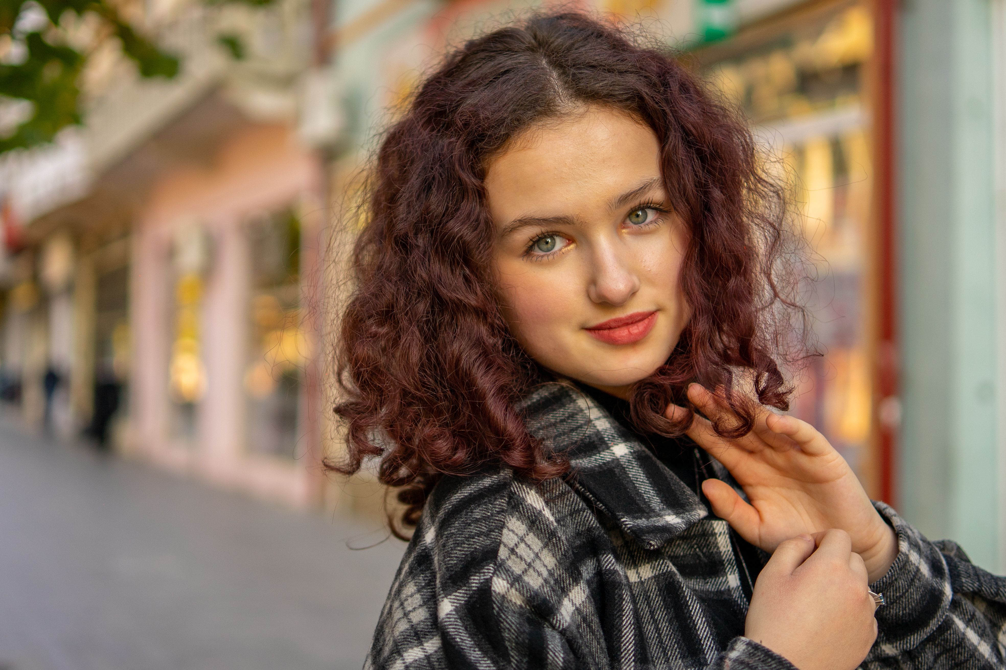 Portrait of a Beautiful Woman with Brown Curly Hair · Free Stock Photo