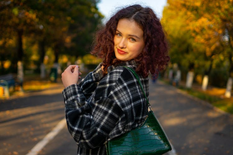 Woman In Black And White Flannel Plaid Shirt Standing In The Middle Of The Street